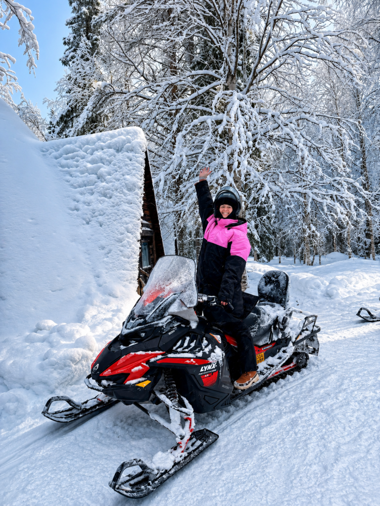 Snowmobile safari across a snowy Lapland landscape.